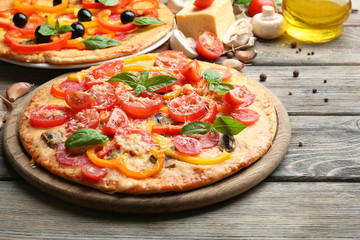 Delicious pizza served on wooden table