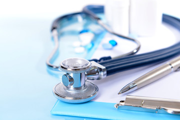 Stethoscope on light blue background