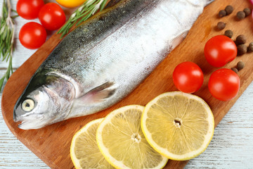 Fresh raw fish and food ingredients on table