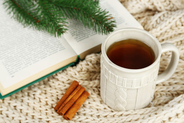 Cup of tea with book on table close-up