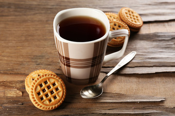 Cup of tea with cookies on table close-up