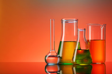 Test tubes with liquid on colorful background
