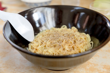 Noodles in black bowl