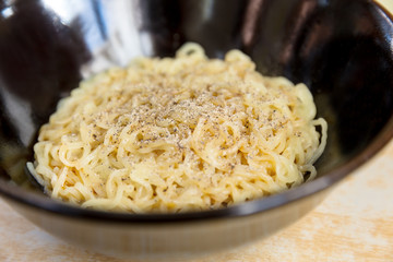 Noodles in black bowl