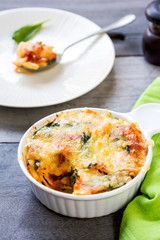 Baked pasta with spinach in tomato sauce
