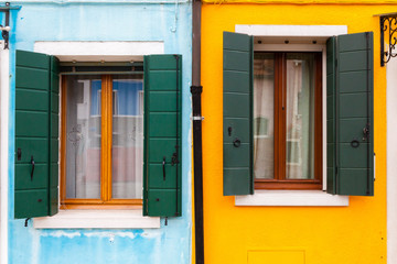 Colorful windows on yellow and blue wall