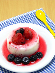 milk pudding dessert with strawberry and blue berry