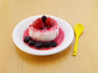 milk pudding dessert with strawberry and blue berry
