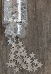 silver stars for christmas on a old wooden background