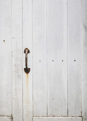 Wooden door with handle close up texture background