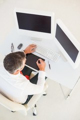 Fototapeta na wymiar Businessman using computer and tablet