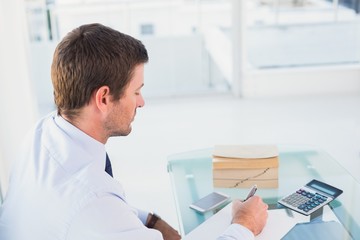 Fototapeta premium Businessman working on his finances at his desk