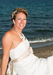 Fototapeta na wymiar Bride on her wedding day next to the Mediterranean Sea
