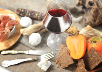 red wine glass with winter laid table in the background