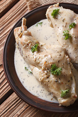 Stew rabbit in sour cream sauce close-up vertical