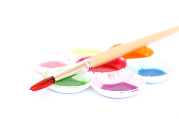 Watercolor paint with brush.