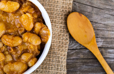 baked beans in bowl on wood close up