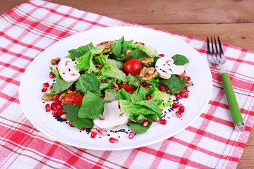 Fresh salad with greens, garnet and spices