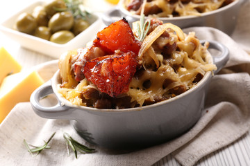 Pasta baked with vegetables and cheese in ceramic pot