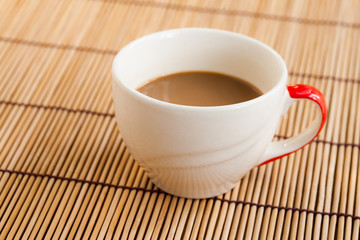 Cup of hot coffee on wooden table.