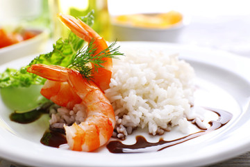 Boiled rice with shrimps served on table, close-up