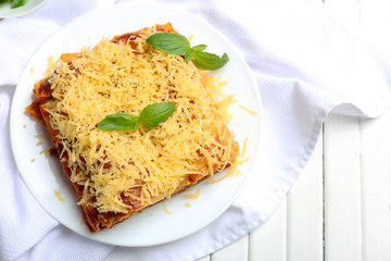 Portion of tasty lasagna on table