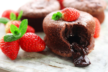 Hot chocolate pudding with fondant centre with strawberries,