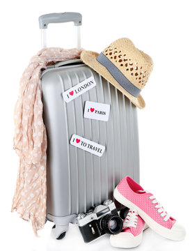 Travel suitcase, converse, photo camera and hat isolated
