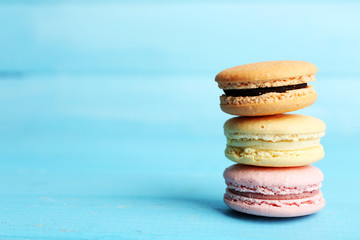 Gentle colorful macaroons on color wooden background