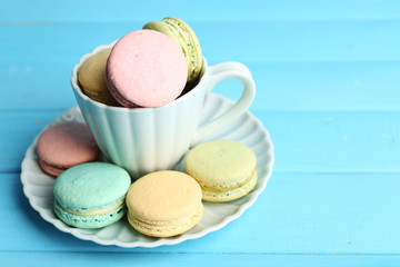 Assortment of gentle colorful macaroons in colorful mug