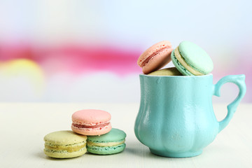 Assortment of gentle colorful macaroons in colorful mug