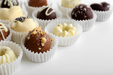 Delicious chocolate candies on white background