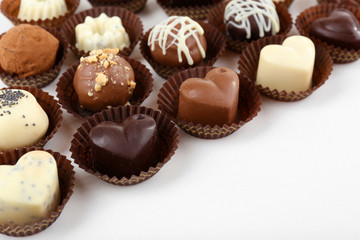 Delicious chocolate candies on white background