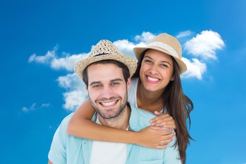 Happy casual man giving pretty girlfriend piggy back