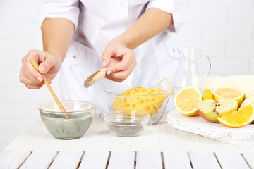 Beautician makes cosmetic facial masks, close-up