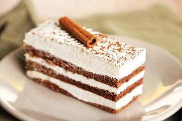 Tasty tiramisu cake on plate, close up