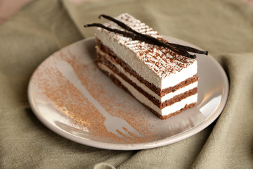 Tasty tiramisu cake on plate, close up