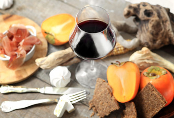 wine glass with christmas laid table over rough wood