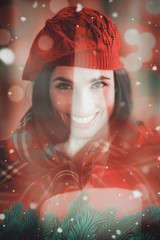 Fototapeta na wymiar Composite image of smiling brunette with cover and red hat