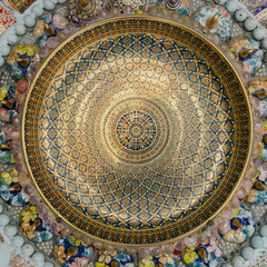 Walls adorned with a thai style color ceramic cup and bowl.