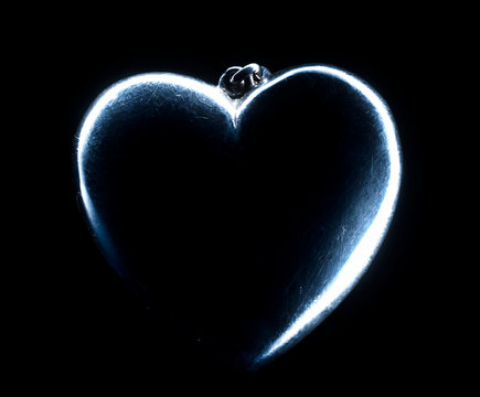 Heart shape emerging from a black background.