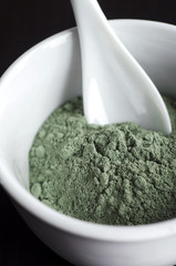 Green cosmetic clay in a bowl