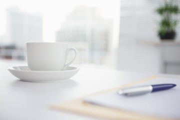 Coffee cup and saucer on desk