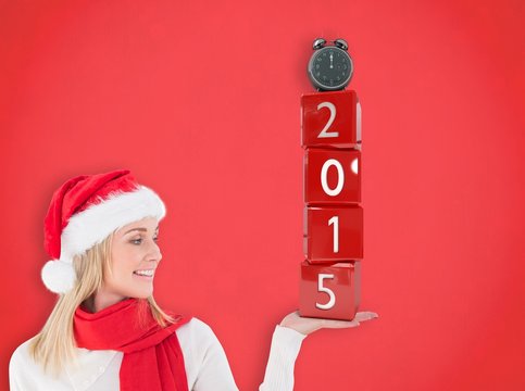 Composite image of festive blonde holding hand out