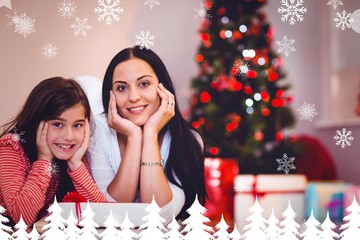 Composite image of festive mother and daughter smiling at camera