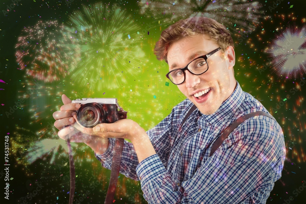 Poster Composite image of geeky hipster holding a retro camera
