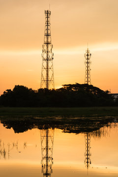 Silhouette telecommunications towers on sunrise