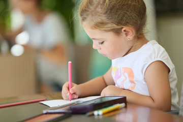 Cute little girl making drawings