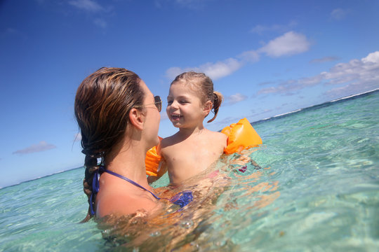 Mother and daughter swimming in Caribbean sea