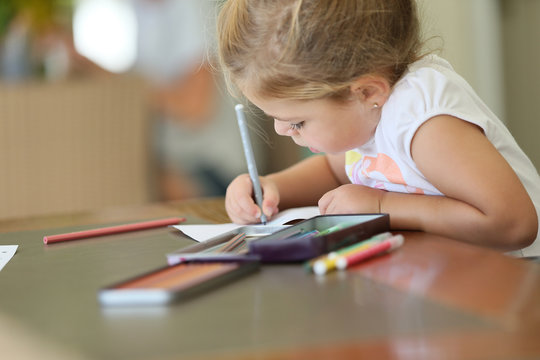 Cute little girl making drawings